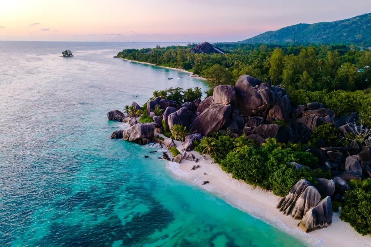 Anse Source d'Argent iconic beach in Seychelles famous for pink-hued sand, granite boulders, and crystal-clear turquoise waters.