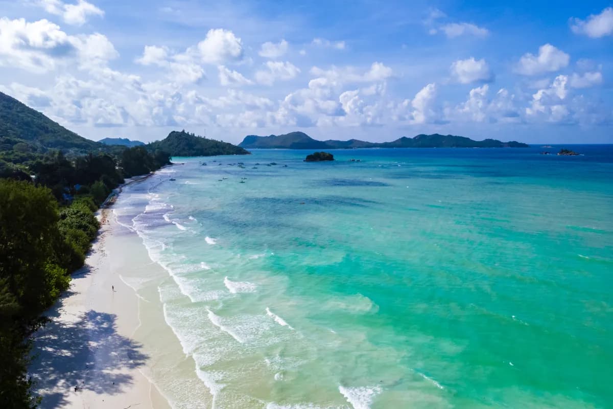 Anse Volbert popular beach in Seychelles known for calm turquoise waters, white sand, and nearby coral reef snorkeling spots.