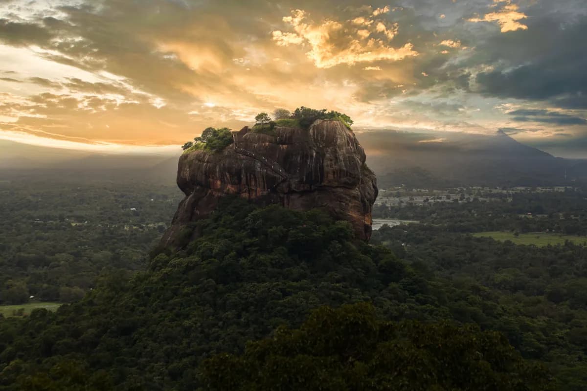 Sigiriya ancient rock citadel in Sri Lanka rising above forests, offering striking sunset silhouettes, historic frescoes, and royal palace ruins.