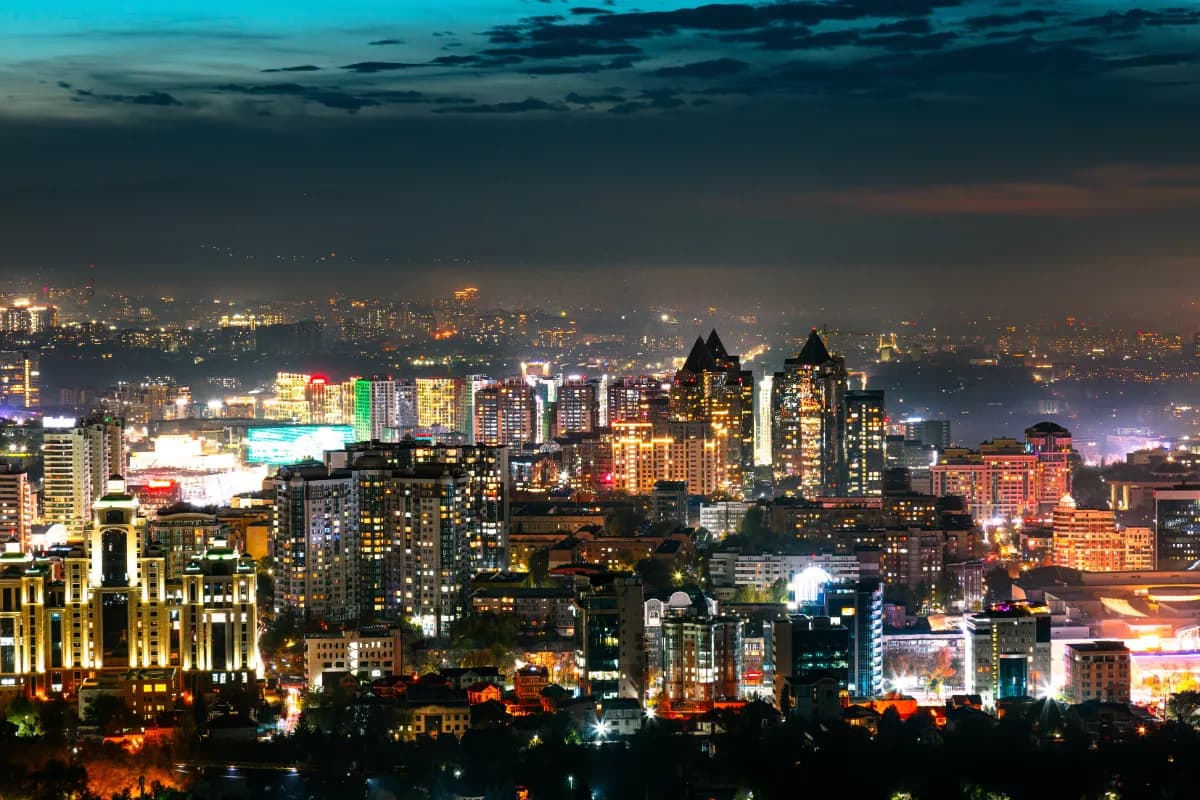 Almaty vibrant city in Kazakhstan known for its illuminated night skyline, mountain backdrop, modern architecture, and lively urban atmosphere.